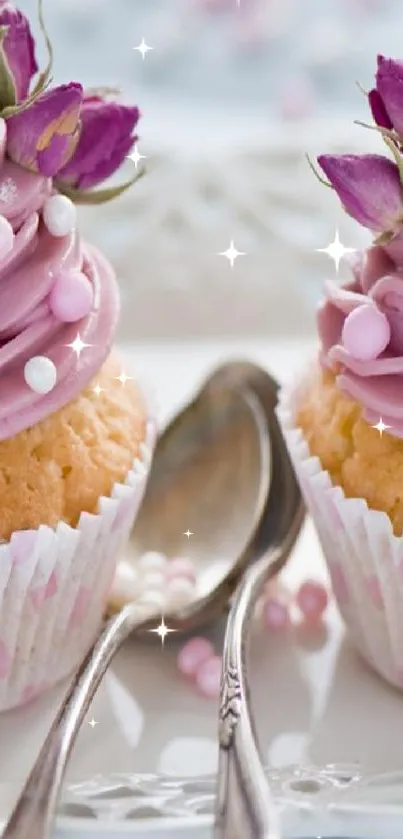 Pink decorated cupcakes on vintage plate with spoons.