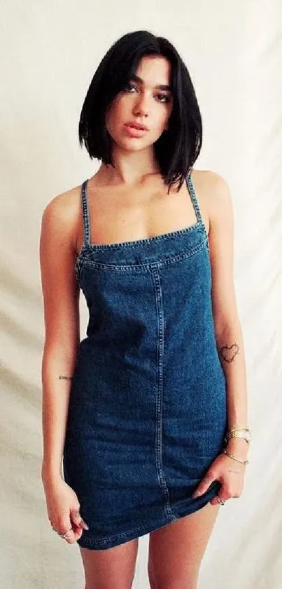 Woman in a denim dress on a minimalist background wallpaper.