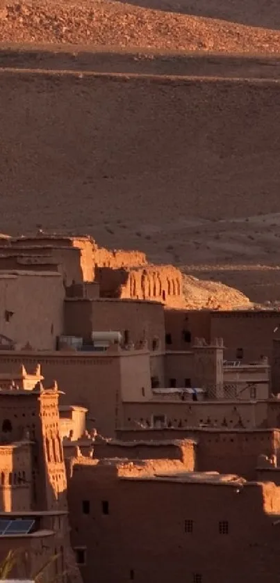 Adobe village in the desert at sunset, showcasing rustic architecture and earthy tones.