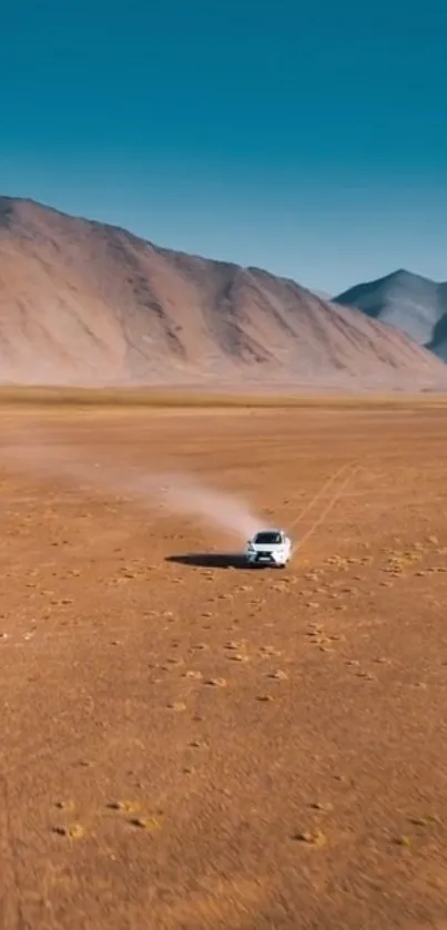 Car driving through vast desert landscape with mountains.