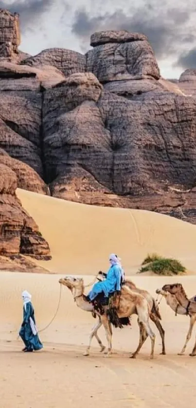 Camels in a majestic desert landscape with sand dunes and rocky cliffs.