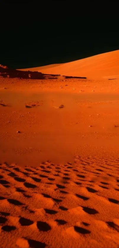 Orange desert dunes at dusk under a darkening sky.