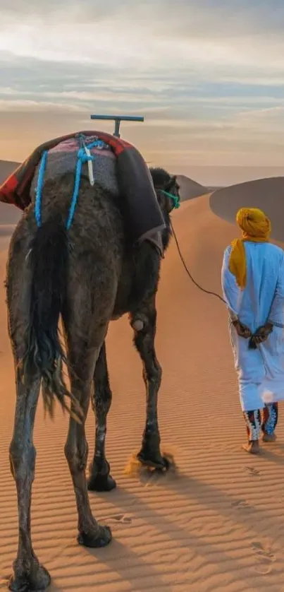 Camel and man walking in desert landscape with sandy dunes.