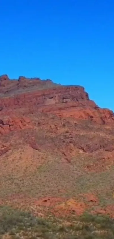 Red desert mountain under clear blue sky wallpaper.