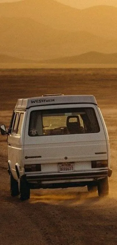 Van driving in golden desert landscape at sunset.