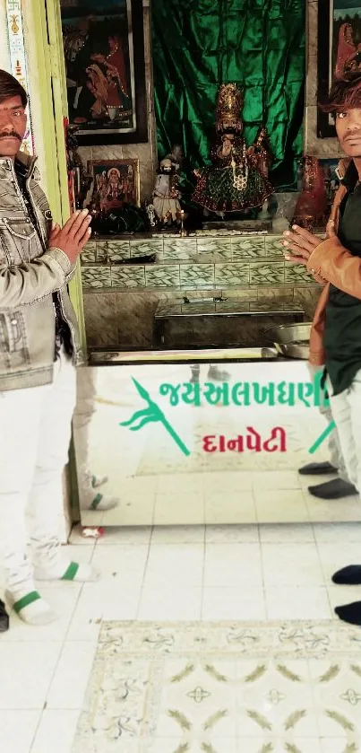 A cultural shrine with two people in traditional attire offering devotion.