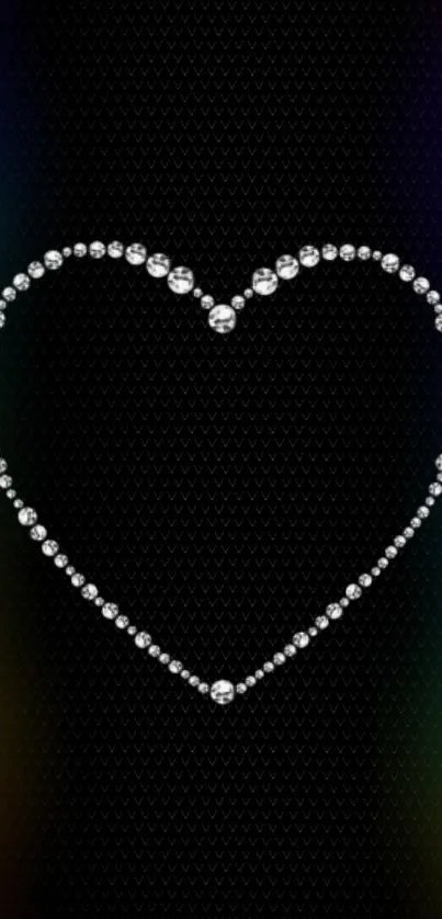 Diamond heart with rainbow glow on black textured background.