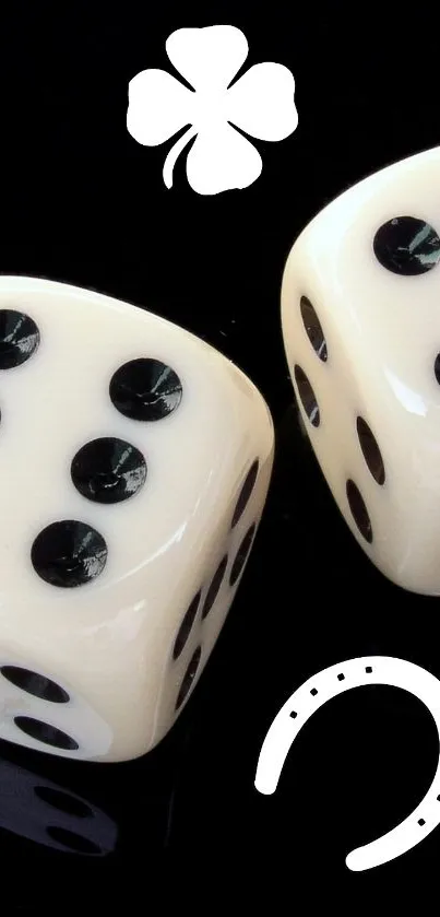 Ivory dice with clover and horseshoe on black background.