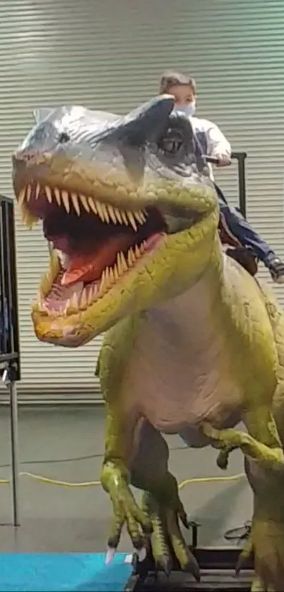 Child riding a realistic dinosaur model.