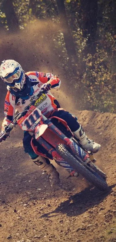 Motocross rider on dirt bike racing through a forest trail.