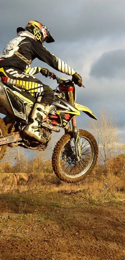 Motocross rider in action on a dirt track.