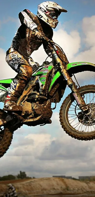 Dirt bike rider soaring mid-jump against a bright sky.