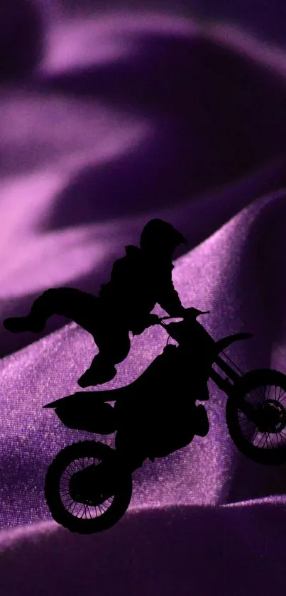 Silhouette of a rider on a dirt bike with a purple wave background.