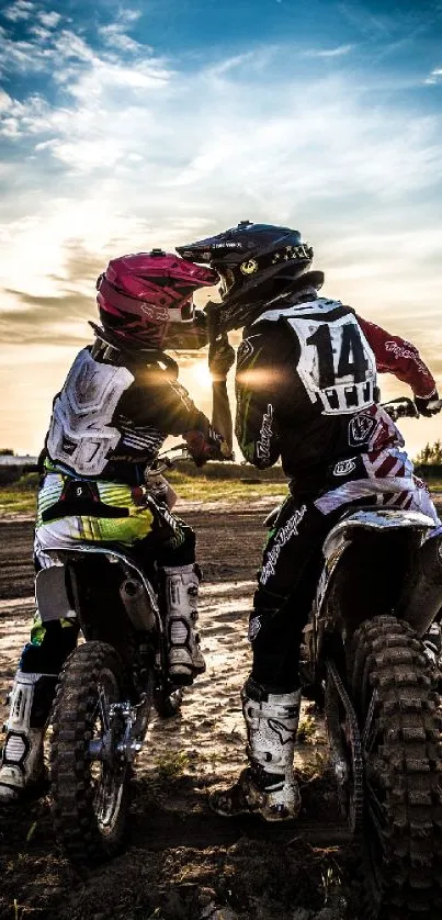 Motocross riders at sunset on dirt bikes, sharing an adventurous moment.