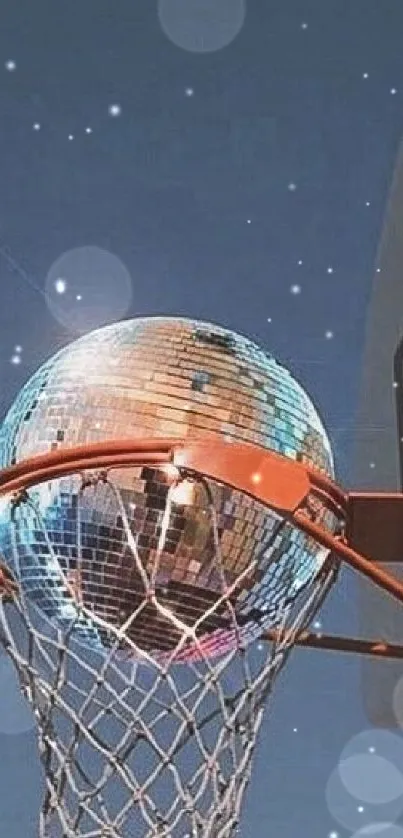 A disco ball inside a basketball hoop under a clear blue sky.