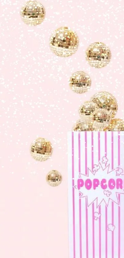 Disco balls and popcorn box on a pink background.