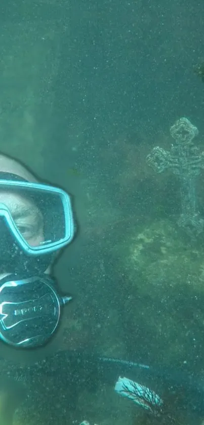 Diver explores underwater cross in teal ocean wallpaper.