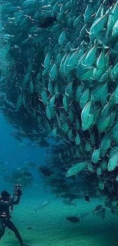 Diver surrounded by school of fish in blue ocean.