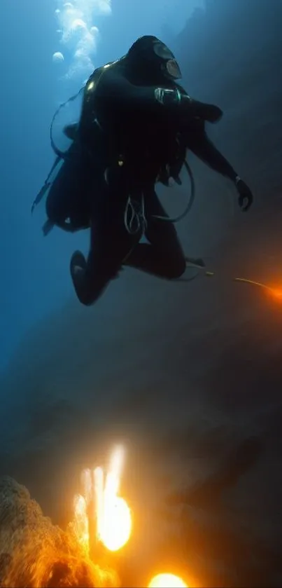 A diver exploring the deep blue ocean with vibrant lights below.