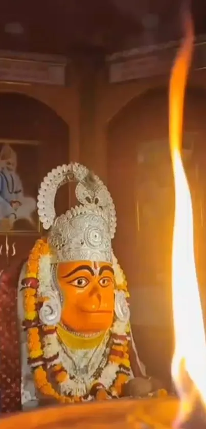 Mobile wallpaper of a deity with a glowing flame, capturing spirituality.