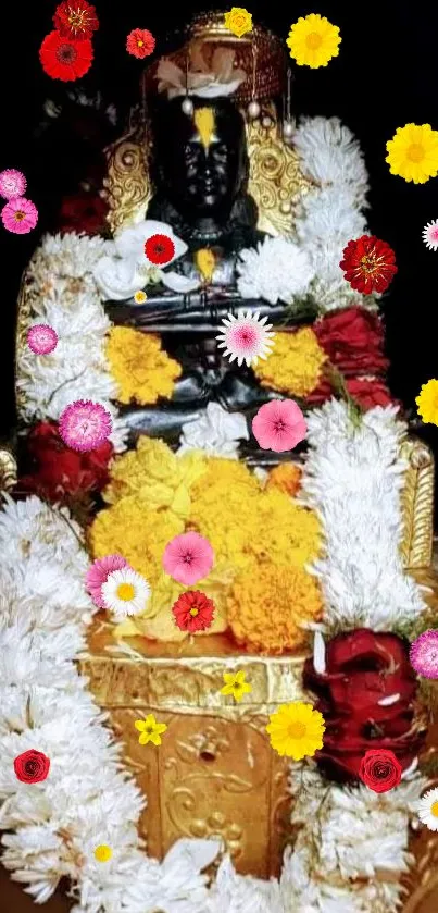 Deity adorned with colorful floral garlands on a golden background.