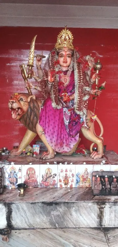 Goddess Durga statue with red background.