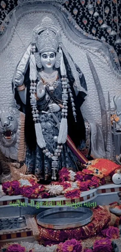 Divine goddess statue in a beautifully decorated temple with vibrant floral offerings.