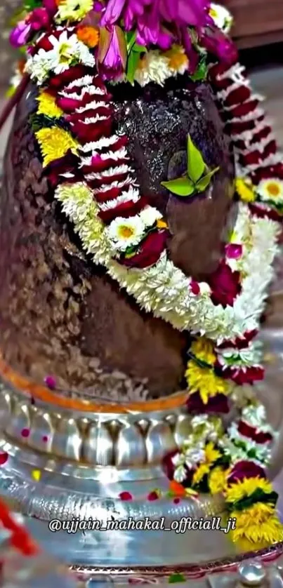 Shiva Lingam adorned with colorful flowers.