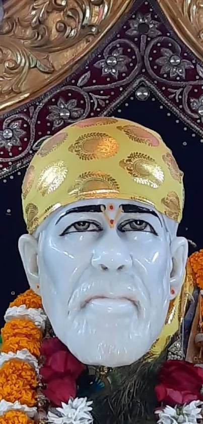 Sai Baba portrait with gold headdress and floral garlands.