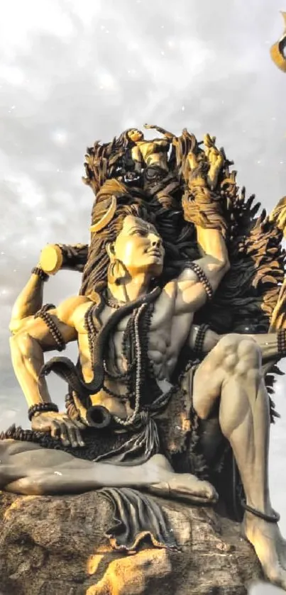 Artistic statue of Lord Shiva against a cloudy sky.