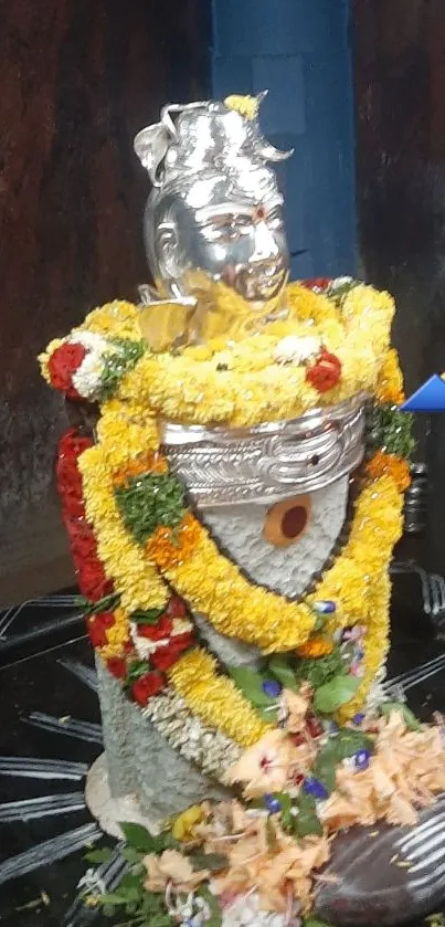 Shiva Lingam adorned with colorful flowers.