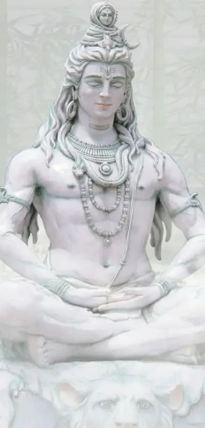 Serene meditation statue of Lord Shiva against a misty background.