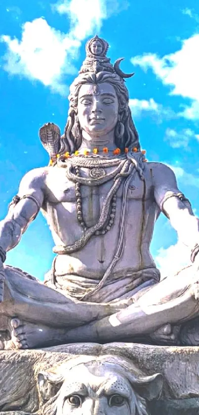 Serene Lord Shiva statue with sky background wallpaper.