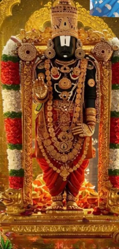 Golden temple deity adorned with flowers.