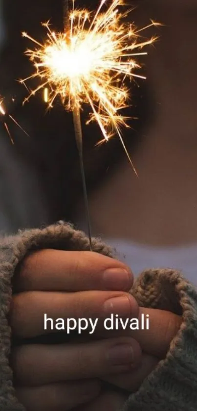 Hand holding a sparkler with festive glow, celebrating Diwali.