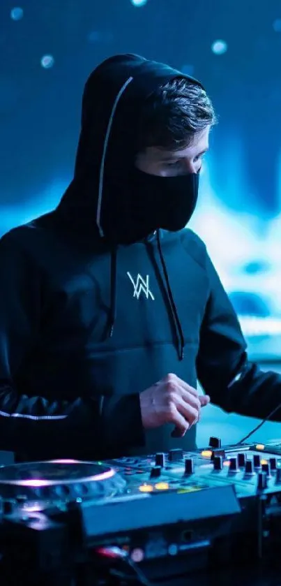 DJ in a dark hoodie at an electronic music night event.