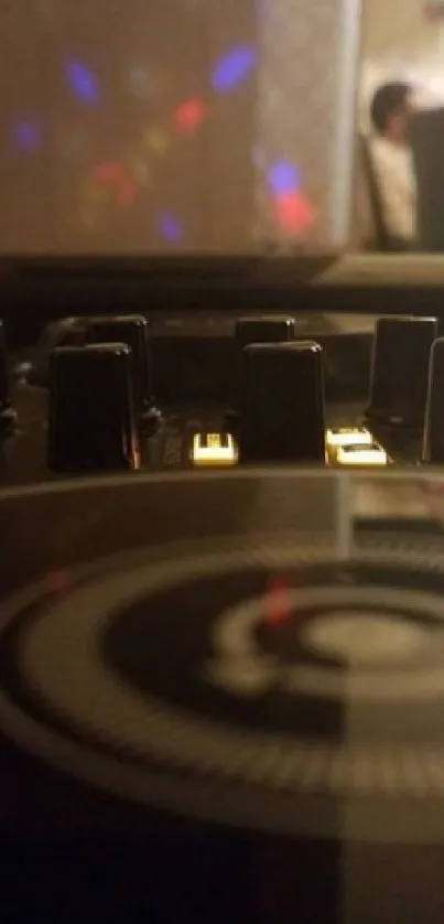 Close-up of DJ console with warm lighting at a party event.