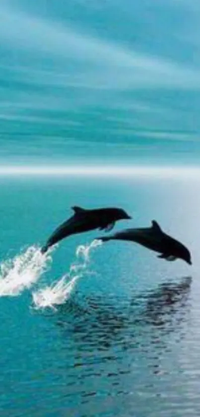 Two dolphins leaping over shimmering blue ocean waves.