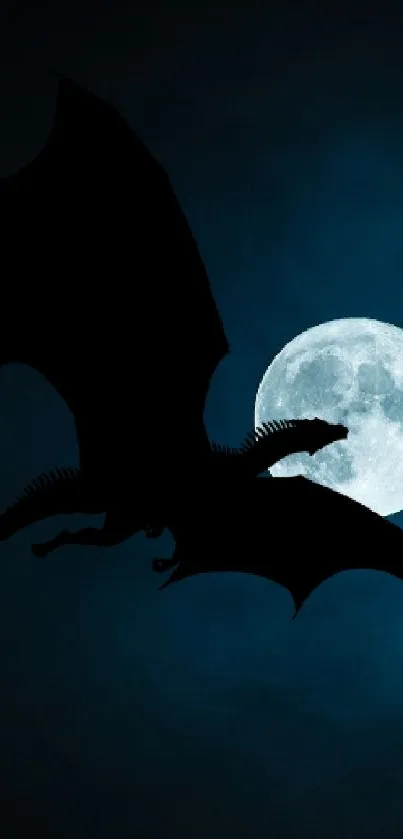 Silhouette of a flying dragon against a bright full moon in a deep blue night sky.