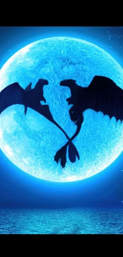 Dragons silhouetted against a vivid blue moon on a starry night.