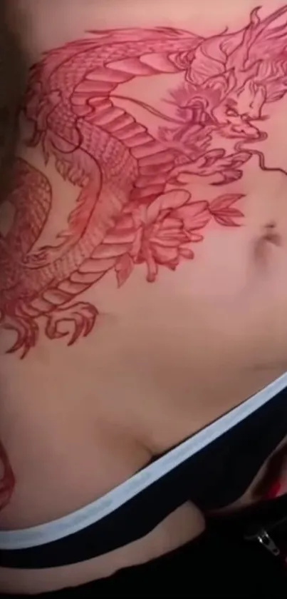 Close-up of red dragon tattoo on skin.