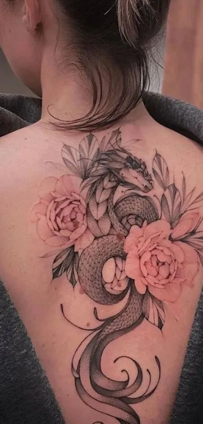 Dragon tattoo design with floral elements on a back, perfect for mobile wallpaper.