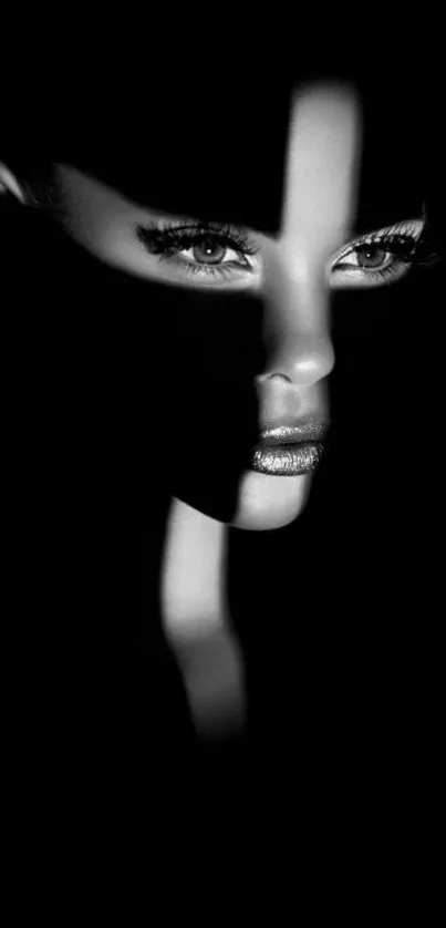 Striking black and white portrait with dramatic shadows and captivating eyes.