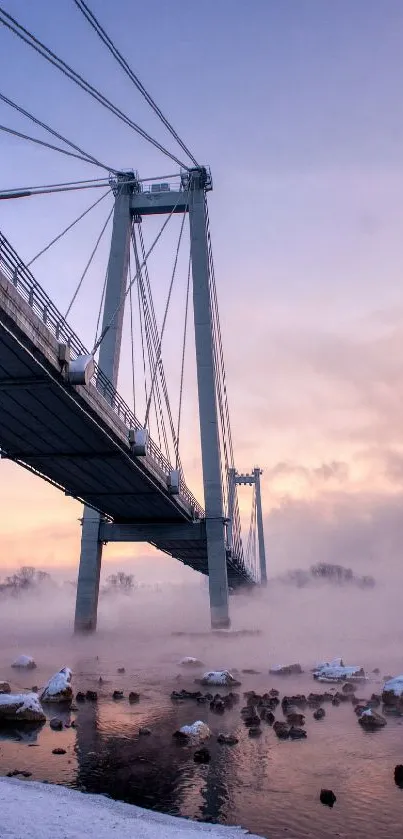 Bridge at sunset with misty, serene beauty and frozen river view.