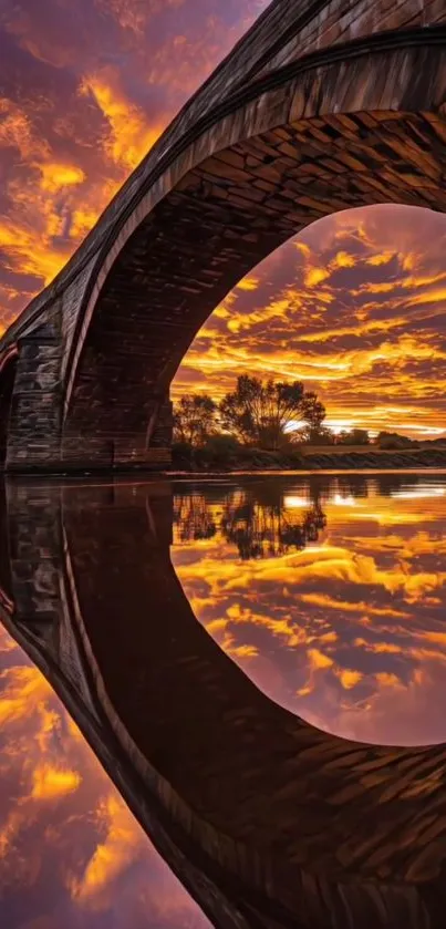 Sunset through bridge arch reflected on water.