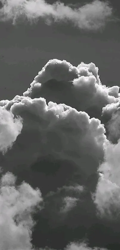 Grayscale wallpaper of dramatic cloud formations against a dark sky.