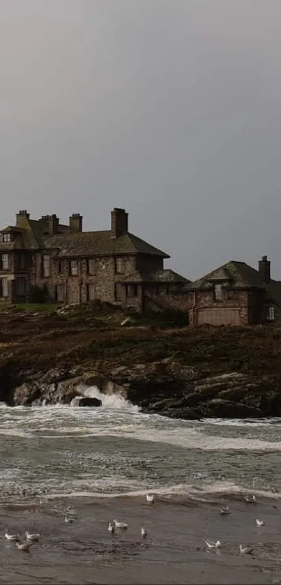 Coastal house with dramatic skies and ocean waves in a serene landscape wallpaper.