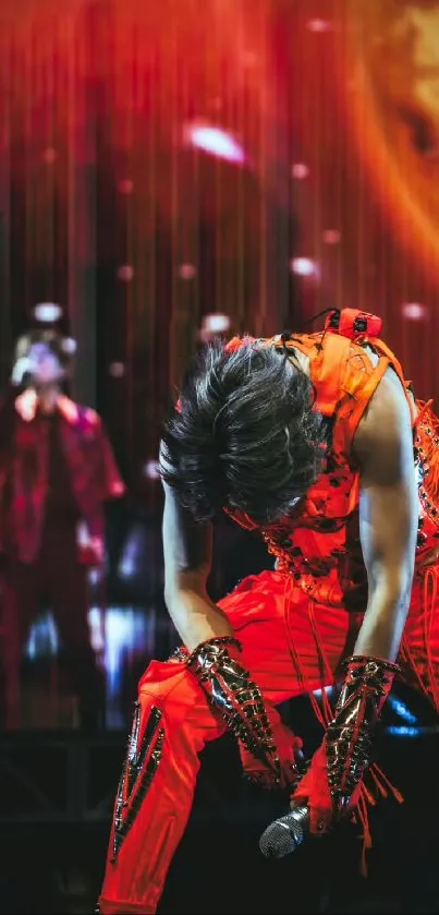 Vibrant red concert performer on stage with intense backdrop.