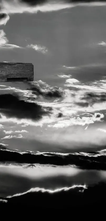 Silhouette of a cross against a dramatic, cloud-filled sky.