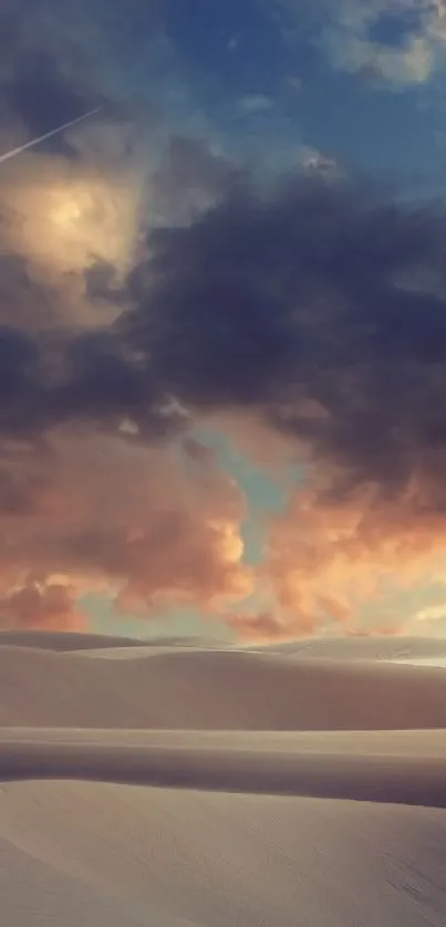 Desert dunes under dramatic sky at sunset